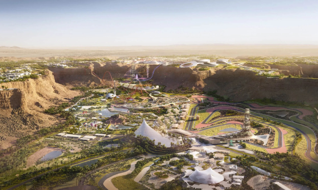 Luftaufnahme einer Wüstenstadt mit Gebäuden, Bäumen, Straßen, Fahrgeschäften und Wasserfeatures, Teil der Dubai Expo 2020.