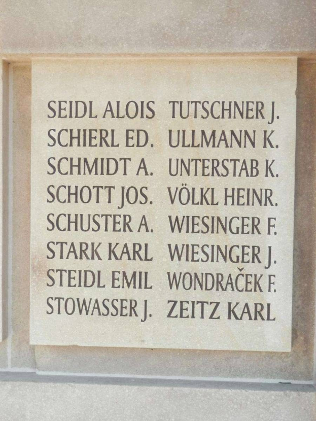Plaque on a building with the names "Seidl Alois Tutschner J. Schierl Ed. Ullmann K. Schmidt A. Unterstab K." engraved on it.