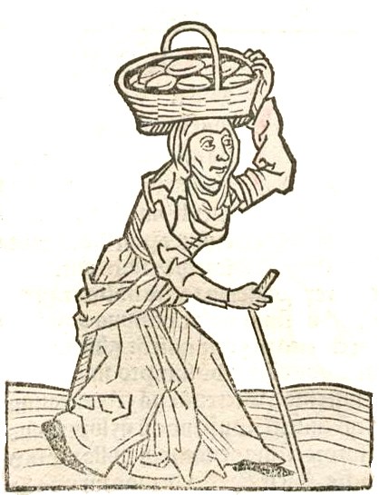 Eine entschlossene Frau mit einem Korb auf dem Kopf hält einen Stock, einfach gekleidet und mit starker Haltung.