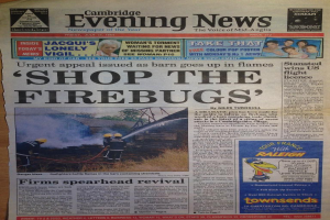 Newspaper front page with multiple advertisements and headlines.