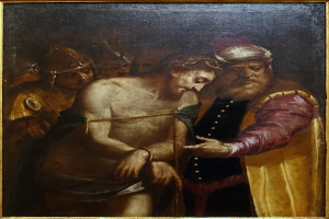 Gemälde eines verzweifelten Mannes mit gesenktem Kopf und gefalteten Händen, der von einer Gruppe weggeführt wird, eingerahmt von einem dunklen Rand, mit staunenden Zuschauern.