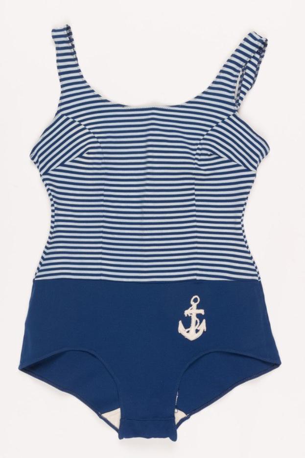 Navy and white striped one-piece swimsuit with an anchor design on the front, displayed against a plain background.