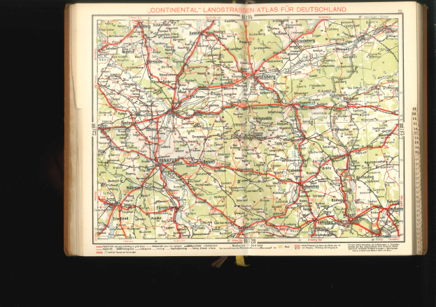 Open book displaying a detailed map of Germany's roads and highways against a black background.