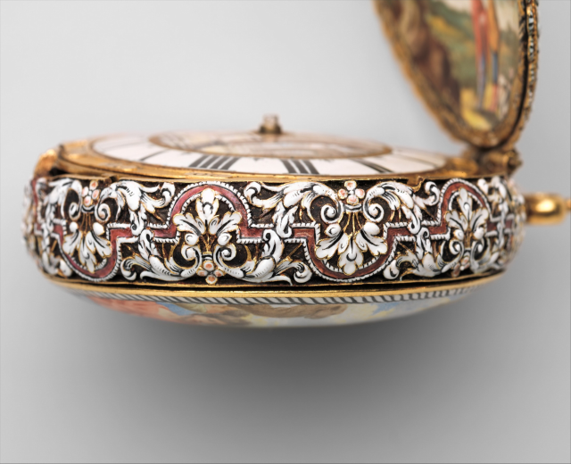 Close-up of a pocket watch with a painted face, featuring intricate encrusted designs and an elegant, luxurious appearance.