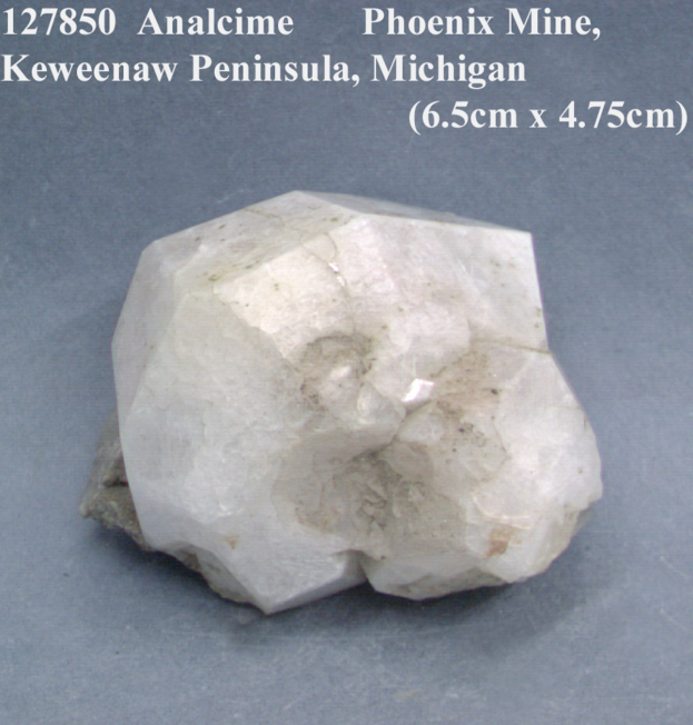 Rock with "127850 Analcime Phoenix Mine, Keweenaw Peninsula, Michigan" text, identified as calcite.