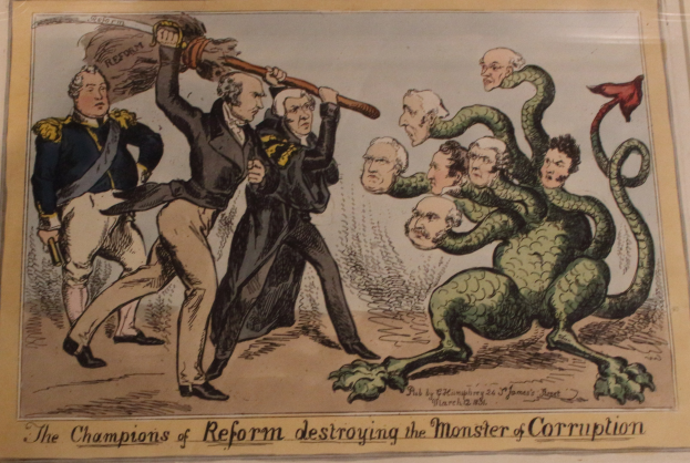 Cartoon-Illustration, die Figuren mit dem Label 'Reformchampions' zeigt, die ein Monster mit dem Label 'Korruption' besiegen, mit begleitendem Text.