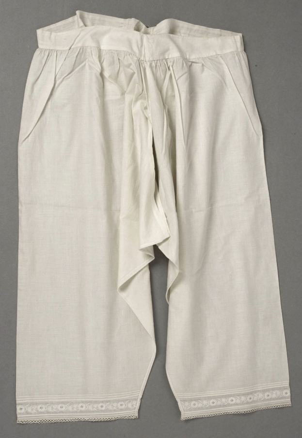 White high-waisted trousers with lace-trimmed waistband, laid flat on a grey surface, featuring wide legs and a subtle sheen.